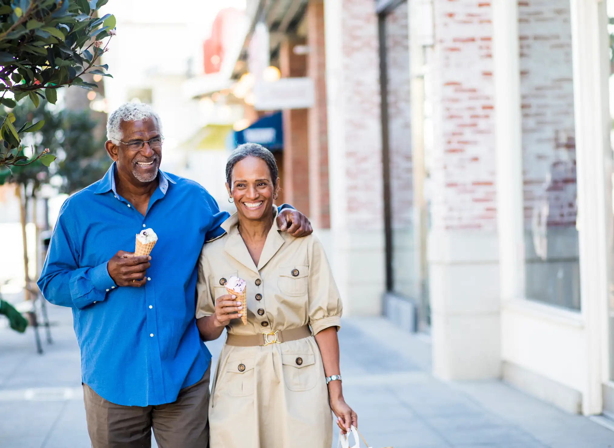 Man and woman walking and eating ice cream near La Villa Lake Apartments